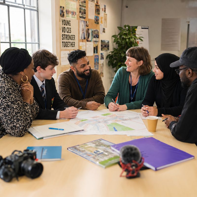 Community members planning a project around a shared table